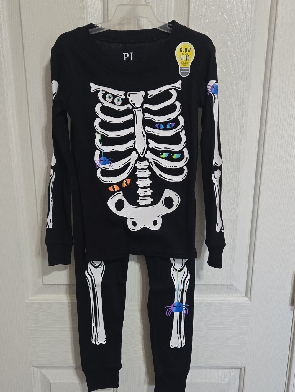 Place Black Glow Skeleton Pajama Set with Colorful Eye Accents